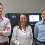 Corey Watson, Ph.D., Melissa Smith, Ph.D., and Oscar Rodriguez, Ph.D., with the Pacific Biosciences Sequel IIe DNA sequencing system, housed in the University of Louisville Sequencing Technology Center