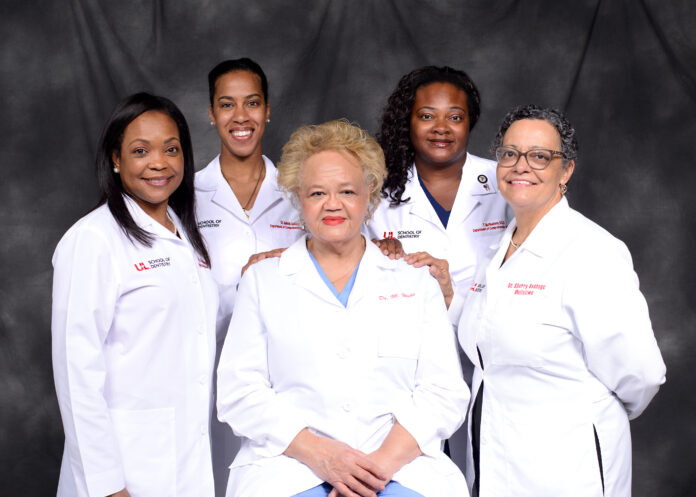 UofL School of Dentistry's African American female faculty members: Madeline Hicks (seated) with Breacya Washington, Amirah Jackson, Tiffany McPheeters and Sherry Babbage (standing L-R).