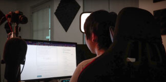 Vinh G works on schoolwork at a dual-screen computer setup.