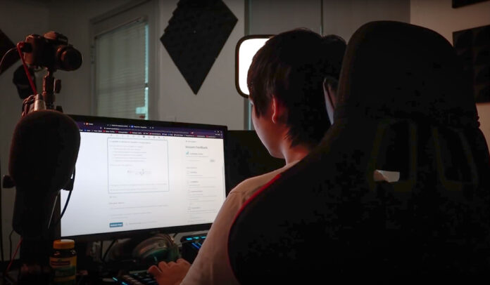 Vinh G works on schoolwork at a dual-screen computer setup.