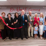 Bob McGuinn and family, along with Wood E. Currens and wife Jennifer join with faculty and students at a ribbon-cutting ceremony