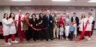Bob McGuinn and family, along with Wood E. Currens and wife Jennifer join with faculty and students at a ribbon-cutting ceremony