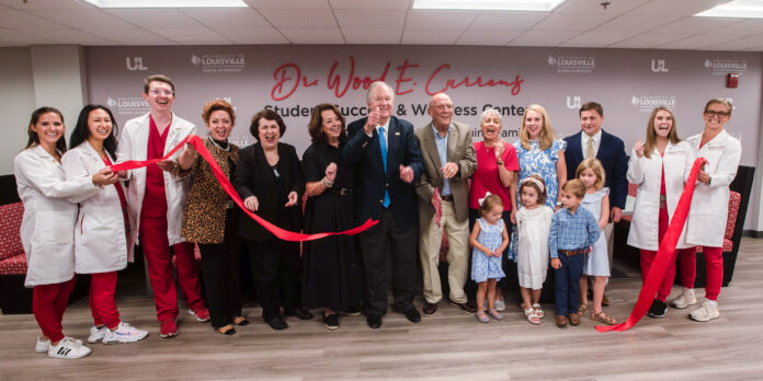 Bob McGuinn and family, along with Wood E. Currens and wife Jennifer join with faculty and students at a ribbon-cutting ceremony