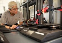Bioengineering student Jack Roeder uses 3-D printing equipment at University of Louisville’s Additive Manufacturing Institute of Science and Technology