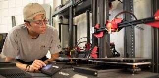 Bioengineering student Jack Roeder uses 3-D printing equipment at University of Louisville’s Additive Manufacturing Institute of Science and Technology