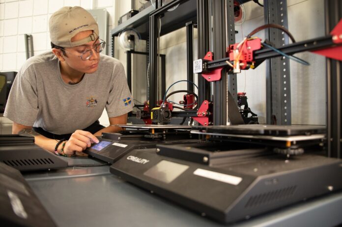 Bioengineering student Jack Roeder uses 3-D printing equipment at University of Louisville’s Additive Manufacturing Institute of Science and Technology