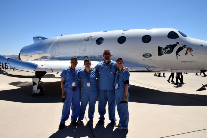 UofL astrosurgery team members George Pantalos, bioengineering student Sienna Shacklette, Tommy Roussel and bioengineering student Clara Jones in front of the Virgin Galactic VSS Unity SpaceShipTwo at Spaceport America in New Mexico. Photo courtesy Virgin Galactic.