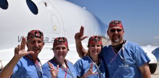 UofL astrosurgery team members George Pantalos, bioengineering student Sienna Shacklette, Tommy Roussel and bioengineering student Clara Jones in front of the Virgin Galactic VSS Unity SpaceShipTwo at Spaceport America in New Mexico.