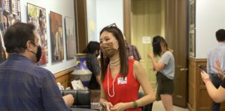 Stella Wang speaking with fellow event attendee at an AAPI event.