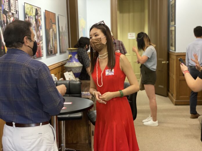 Stella Wang speaking with fellow event attendee at an AAPI event.