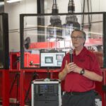 Mark McGinley, professor and Endowed Chair for Infrastructure Research in UofL’s Department of Civil and Environmental Engineering with the actuator system at the Dahlem Infrastructure Structural Testing Lab Facility.
