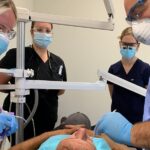 WKCTC Dental assisting program student Lakin Reed (left) assists Dr. Gregory Lord (right) with a recent procedure as UofL dental students Virginia Dunlap (left) and Allison Reed (right) observe.