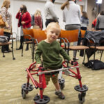 Luke Madson on a specially designed pediatric treadmill for therapy at the Kosair Charities Center for Pediatric Neurorecovery