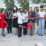 UofL leaders, along with staff and students cut a ribbon symbolizing the opening of the Cultural and Equity Center.