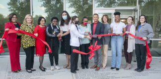 UofL leaders, along with staff and students cut a ribbon symbolizing the opening of the Cultural and Equity Center.