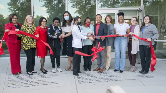 UofL leaders, along with staff and students cut a ribbon symbolizing the opening of the Cultural and Equity Center.
