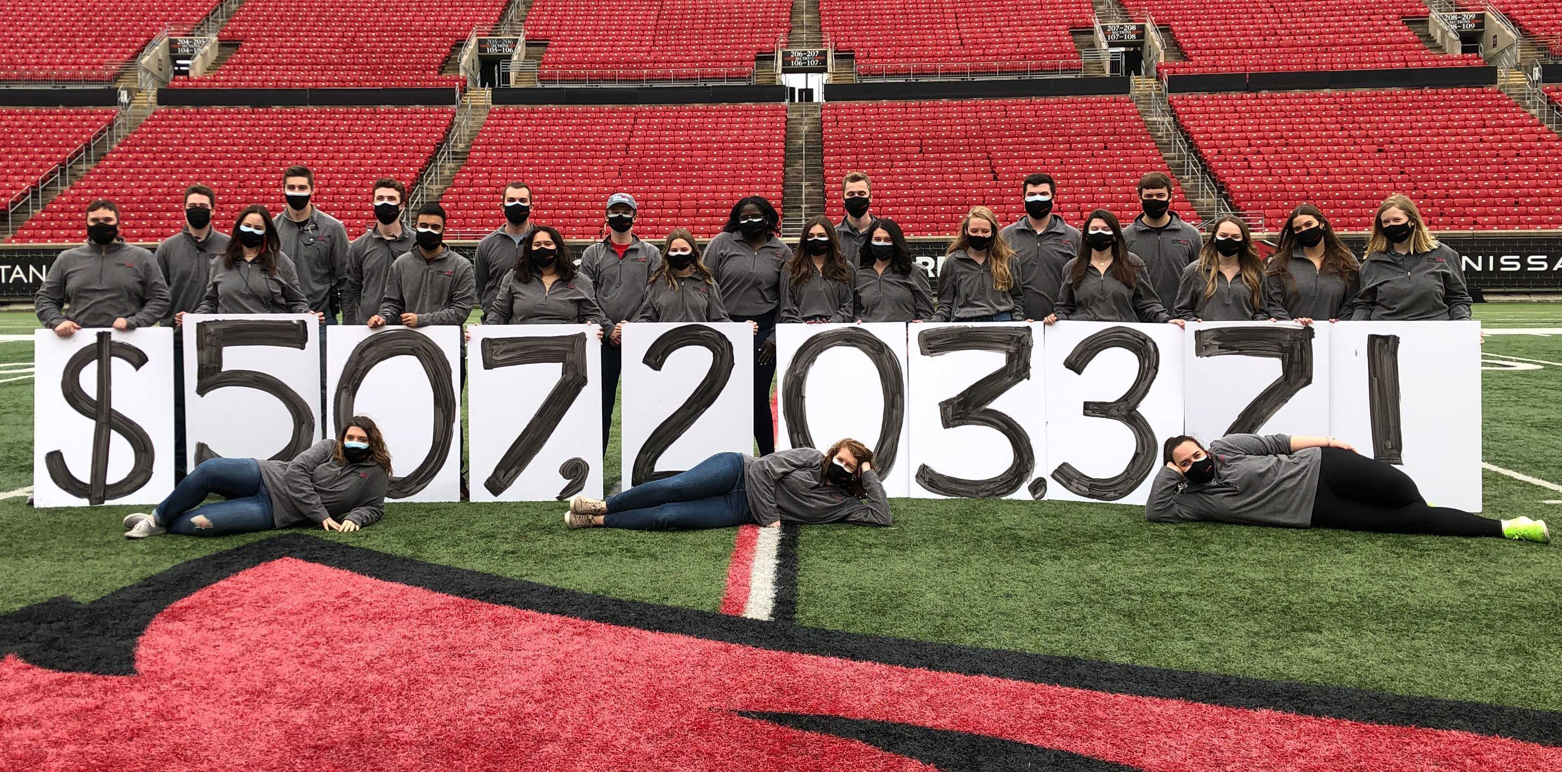 raiseRED students holding their $507,203.37 total