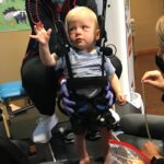 Luke Madson on a specially designed pediatric treadmill for therapy at the Kosair Charities Center for Pediatric Neurorecovery