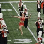 Morgan Proctor performing on the field at Cardinal Stadium.