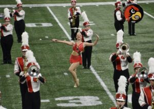 Morgan Proctor performing on the field at Cardinal Stadium.