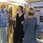 Graduate fellow Kate Tarvestad delivers her poster presentation at the Research!Louisville symposium.