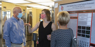 Graduate fellow Kate Tarvestad delivers her poster presentation at the Research!Louisville symposium.