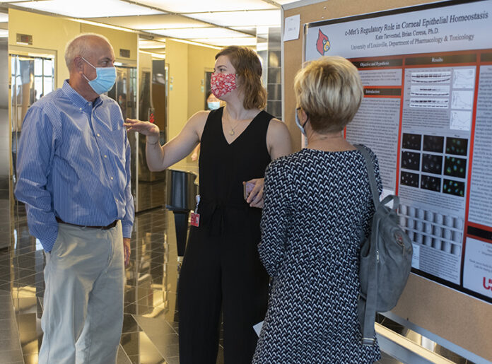 RL Posters_7613 Kate Graduate fellow Kate Tarvestad delivers her poster presentation at the Research!Louisville symposium.