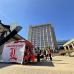 Student donors could win a prize and take a selfie against a campaign backdrop at campus headquarters during the Raise Some L day of giving.