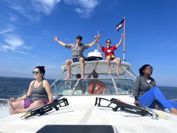 John Pierce Wise Sr. center, with members of his research team during an expedition to collect whale cells. Left to right: Idoia Meaza, grad student, Johnny Wise, assistant professor, Rick Walker, volunteer driver, Jennifer Toyoda, grad student, and Aggie Williams, grad student