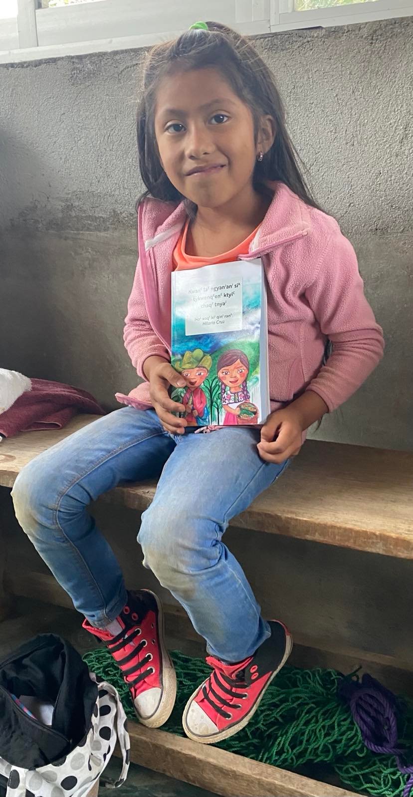 A child in Mexico holds one of the books.