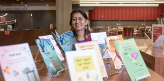 Hilaria Cruz with the children's books she wrote with the help of UofL students in her endangered languages course. The books are on display at Ekstrom Library as part of International Mother Language Day and the UNESCO's celebration of Indigenous Languages Decade.