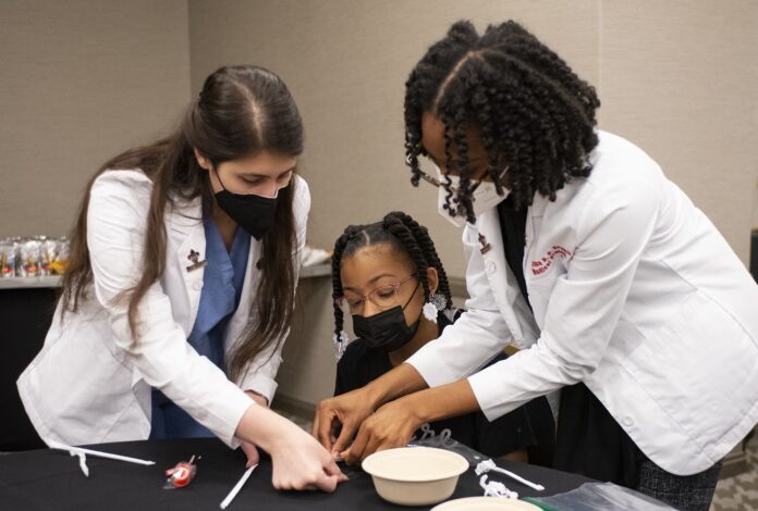 Nadieh Rahbari and Rheyana Branch work with one of the Future Healers Ambassadors