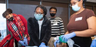 Diane Appiasie and other Porter Scholars in Medicine Program participants take part in a medical simulation experience.