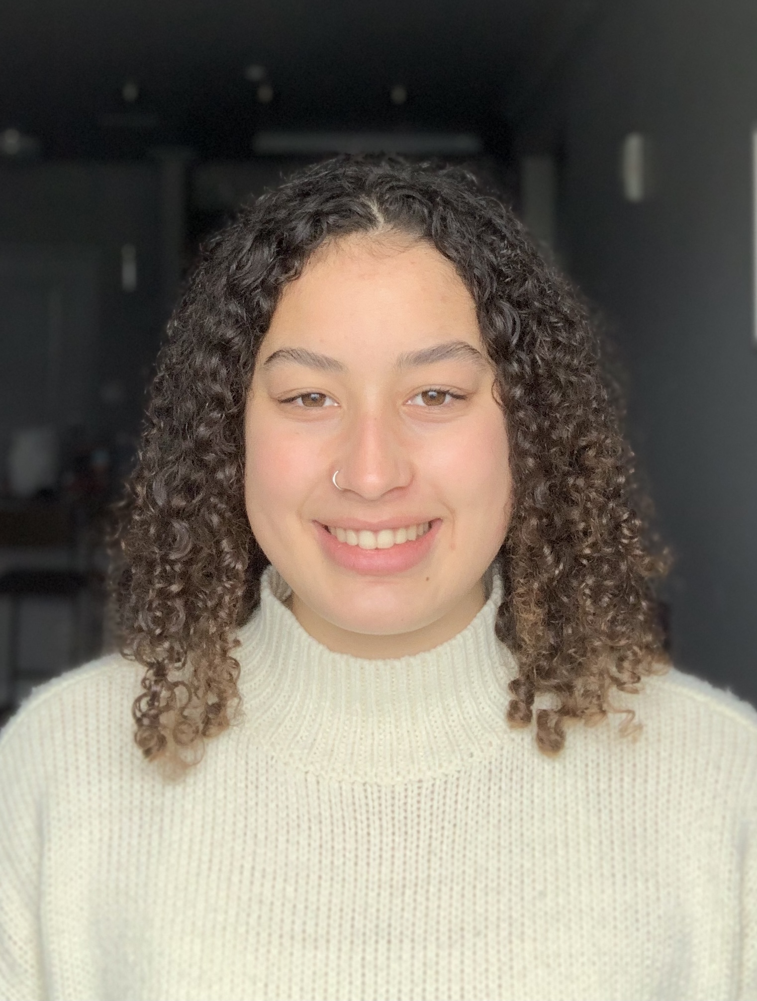 Curly haired female student smiling