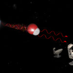 Artist’s impression of a hydroxyl maser. Inside a galaxy merger are hydroxyl molecules, composed of one atom of hydrogen and one atom of oxygen. When one molecule absorbs a photon at 18 cm wavelength, it emits two photons of the same wavelength. When molecular gas is very dense, typically when two galaxies merge, this emission gets very bright and can be detected by radio telescopes such as the MeerKAT. © IDIA/LADUMA using data from NASA/StSci/SKAO/MolView (Link for more information)