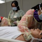 Nursing students engaged in simulation learning.