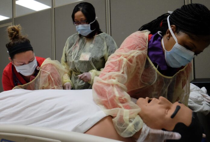 Nursing students engaged in simulation learning.