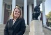 Laurie Young, pictured in front of The Thinker statue on UofL’s Belknap campus, is a UofL graduate with sales and business development experience. (UofL Photo)