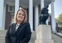 Laurie Young, pictured in front of The Thinker statue on UofL’s Belknap campus, is a UofL graduate with sales and business development experience. (UofL Photo)