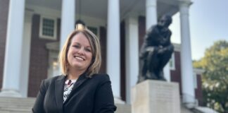 Laurie Young, pictured in front of The Thinker statue on UofL’s Belknap campus, is a UofL graduate with sales and business development experience. (UofL Photo)
