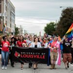 Representatives organized by UofL's LGBT Center march in the 2019 Kentuckiana Pride Parade.