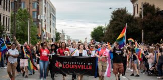 Representatives organized by UofL's LGBT Center march in the 2019 Kentuckiana Pride Parade.