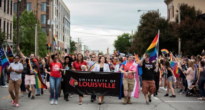 Representatives organized by UofL's LGBT Center march in the 2019 Kentuckiana Pride Parade.