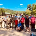 Chelsea Miceli, (center in blue), an employee of the UofL Trager Institute and Republic Bank Foundation Optimal Aging Clinic, with other relief workers who helped victims of the July flooding in Eastern Kentucky.