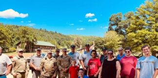 Chelsea Miceli, (center in blue), an employee of the UofL Trager Institute and Republic Bank Foundation Optimal Aging Clinic, with other relief workers who helped victims of the July flooding in Eastern Kentucky.