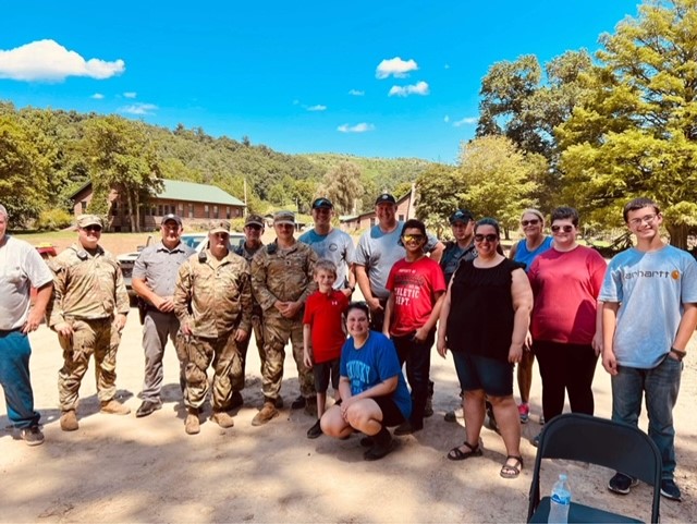 Chelsea Miceli, (center in blue), an employee of the UofL Trager Institute and Republic Bank Foundation Optimal Aging Clinic, with other relief workers who helped victims of the July flooding in Eastern Kentucky.