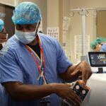 Central High School student LaMya Hickman shadows Edward Miller, UofL assistant professor and director of maternal fetal medicine, at UofL Hospital