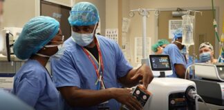 Central High School student LaMya Hickman shadows Edward Miller, UofL assistant professor and director of maternal fetal medicine, at UofL Hospital