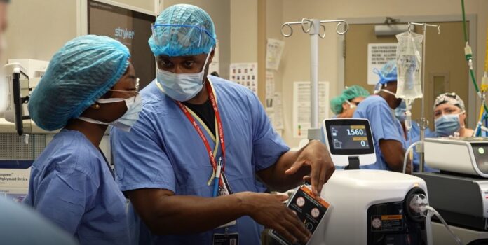 Central High School student LaMya Hickman shadows Edward Miller, UofL assistant professor and director of maternal fetal medicine, at UofL Hospital