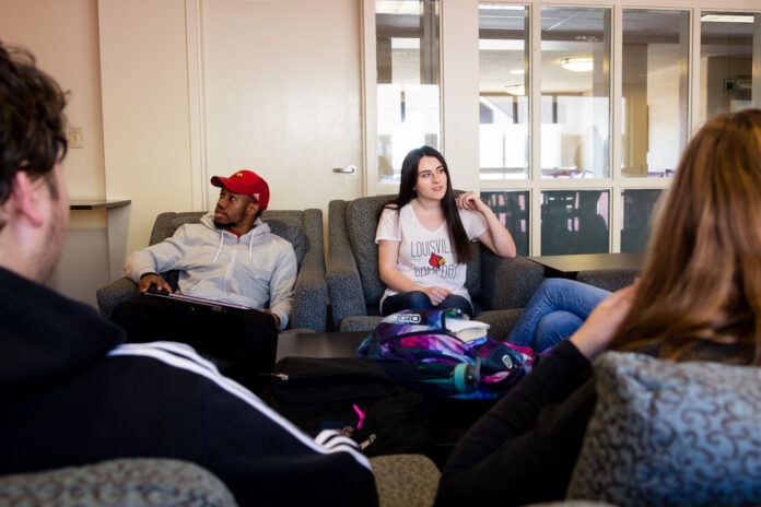 Students study together in their dorm's common area UofL offers living communities where students with similar interests can reside. Twenty-six communities are offered this year.